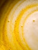 Close Up of Golden Latte Foam, Abstract Coffee Texture. photo
