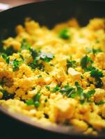 Close Up of Scrambled Eggs with Parsley in a Pan. A delicious and healthy breakfast food. photo
