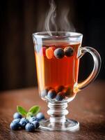 Steaming Cup of Berry Tea with Fresh Blueberries. A close up image of a delicious and warming beverage perfect for a cozy autumn or winter day. photo
