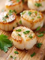Close Up of Seared Scallops with Parsley on Wooden Board. photo