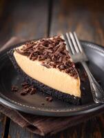 Delicious Slice of Creamy Caramel Chocolate Pie on Dark Plate. photo