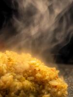 Steaming Hot Cooked Rice with Herbs and Spices, Close Up Food Photography. photo