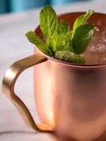 Close up of a Refreshing Drink in a Copper Mug Garnished with Mint. photo