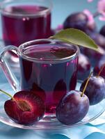 Refreshing Plum Juice in Glass Cups with Fresh Plums. photo