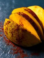 Close Up of Sliced Mango with Chili Powder. A vibrant food photography image perfect for culinary blogs or recipe websites. photo