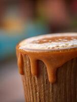 Close up of Caramel Dripping Down Wooden Surface. A delicious image perfect for food blogs, cafes, and dessert menus. photo