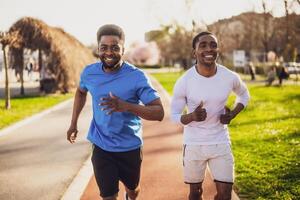 Two muscular friends running side by side on a city running track, enjoying a sunny day workout and healthy lifestyle. photo