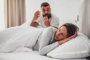 The couple deals with feelings of adultery and mistrust, with visible frustration and sadness in a private setting. photo