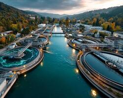 Water treatment plant with circular tanks and autumn forest hills under dramatic cloudy sky at sunset photo