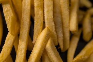 Perfectly golden french fries, generously seasoned with coarse salt, offering a classic fast food experience, ideal for casual dining and satisfying cravings photo