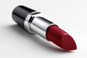 Crimson lipstick with diagonal cut on white background photo
