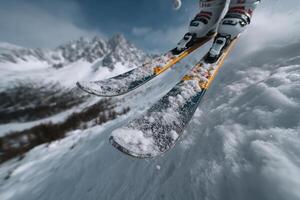 Skier jumps high over snowy mountain at daytime photo