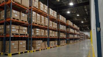 Rows of Cardboard Boxes Stacked on Shelves in a Large Warehouse photo