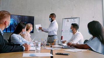 A team gathers in a contemporary office for a strategic meeting. The presenter shares insights on business success using charts and data, while colleagues engage thoughtfully. video