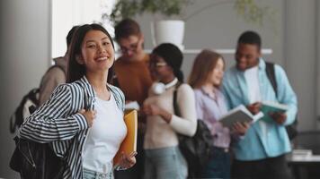 Asian lady posing over group of diverse students collaborates and studies at a university setting, showcasing teamwork among friends. video