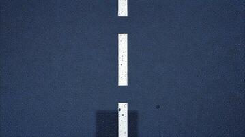A road with white lines on it and a building in the background photo