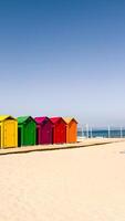 Vibrant cabins line on sandy and sunny beach in Spain. For travel, summer, or vacation concepts in web or print for travel backgrounds. Copy space for text. photo