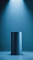 Clean blue cylindrical shape under spotlight set against a tone-matching background perfect for minimalist object photography. photo