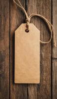 A blank kraft paper tag hanging from a string on a rustic wooden background. Ideal for labeling or crafting purposes. photo