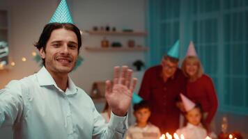 Joyful gathering happens at home during Birthday. Family members, dressed in festive attire, enjoy each other's company and celebrate around a beautifully set table. video