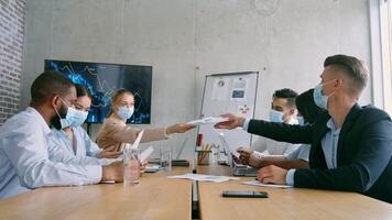 Group of professionals engaged in a productive meeting in a contemporary office, wearing face masks video