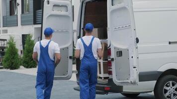 Mover Holding Tablet in Front of Loaded Delivery Van video