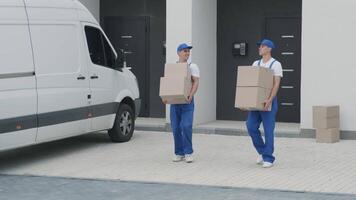 Two workers carrying package to modern house video