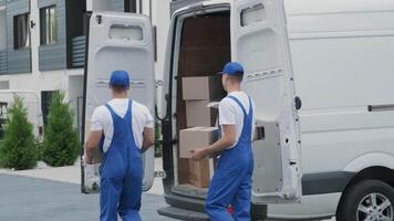 Movers unloading boxes from delivery van video