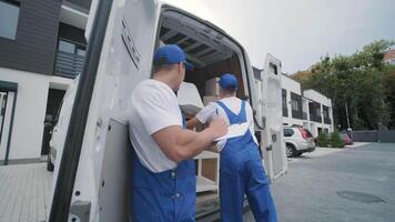 Two Movers Organizing Boxes into Moving Van video