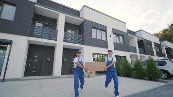 Delivery team transporting box to house video