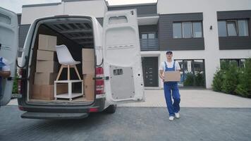Delivery Worker Standing at Open Van with Packages video
