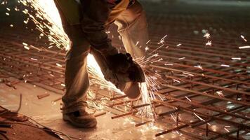 Industrial professional worker is cutting metal rebar with a circular saw. Construction of a factory, hangar 8 video