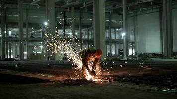 Industrial professional worker is cutting metal rebar with a circular saw. Construction of a factory, hangar 5 video