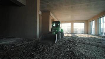 Tractor works in an unfinished building. Internal construction work 2 video