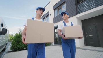 Movers stacking boxes in cargo space video