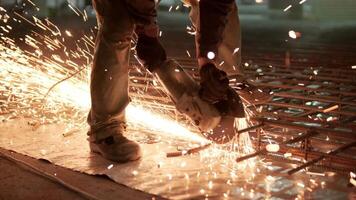 Industrial professional worker is cutting metal rebar with a circular saw. Construction of a factory, hangar 11 video
