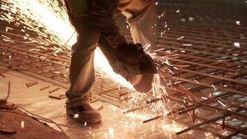 Industrial professional worker is cutting metal rebar with a circular saw. Construction of a factory, hangar 9 video