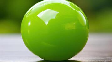 A vibrant green ball reflecting light on a surface. photo