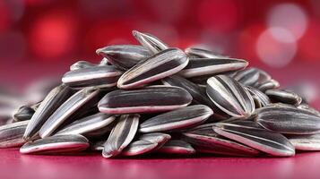 Pile of sunflower seeds against a blurred background. photo