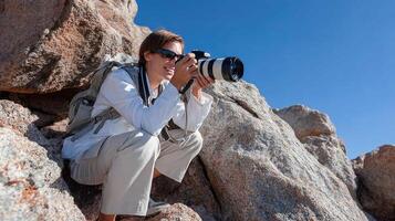 A woman with a camera on a rock photo