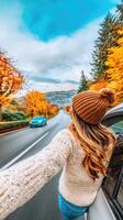 A woman is driving down the road in the fall photo