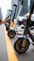 A row of scooters are parked on the street photo