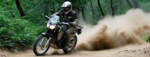 A person riding a motorcycle on a dirt road photo