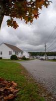 A street with a stop sign and a house photo