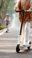 A man riding a scooter down a road photo