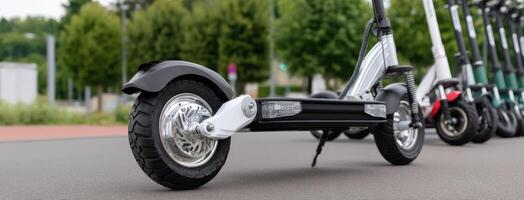A row of electric scooters parked on the street photo