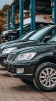 A row of black cars parked in front of a car repair shop photo
