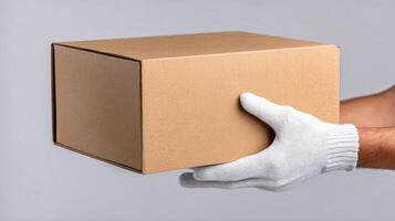 A man in white gloves holding a cardboard box photo