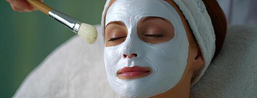 A woman with a facial mask on her face photo