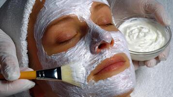 A woman getting a facial with a brush photo